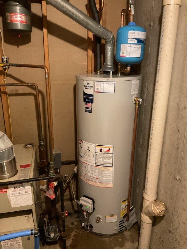 Installed a 50-gallon natural gas water heater with natural draft venting and expansion tank in response to existing unit failure and active leak. Utilized existing piping infrastructure to connect new water heater system, ensuring proper integration with home's plumbing. Repaired dryer vent routing during installation to ensure proper ventilation and code compliance.