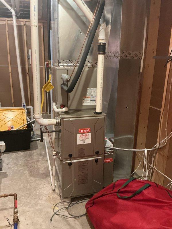 Completed on-site assessment for residential air conditioning system replacement. Evaluated existing Bryant furnace and current HVAC infrastructure in basement utility area, including ductwork configuration, condensate drain lines, and available clearances for new equipment installation. Documented equipment dimensions and existing PVC piping layout to determine compatibility requirements for replacement AC unit. Customer previously received repair estimate from another contractor but opted for full system replacement evaluation instead.
