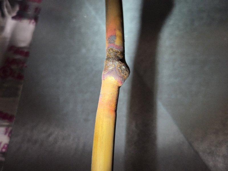 Responded to service call for 9-year-old air conditioning system experiencing frozen refrigerant lines and inadequate cooling performance. Upon inspection, discovered severe corrosion and deterioration on copper refrigerant lines at multiple connection points, including soldered joints and penetration points through exterior housing. The corrosion exhibited advanced oxidation with crusty white deposits and flaking material, indicating prolonged exposure to moisture and potential refrigerant leaks at compromised joints. Documented extensive damage to refrigerant piping system with photographic evidence showing rust, oxidation, and galvanic corrosion concentrated at connection points and soldered areas. System requires refrigerant line replacement due to compromised integrity of copper piping, which is causing recurring freeze-up conditions and reduced cooling capacity.