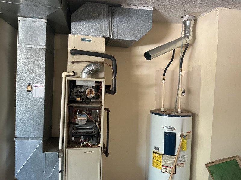Provided comprehensive quote for complete HVAC system replacement including furnace and associated ductwork. Assessed existing equipment configuration in mechanical space, documented current furnace unit with exposed internal components, evaluated galvanized metal ductwork routing, and photographed all equipment connections to prepare accurate replacement estimate.