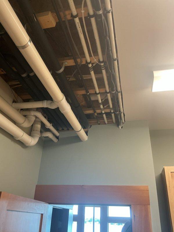 Responded to no cooling call for mini-split system. Upon arrival, diagnosed system malfunction and restored unit to operational status. Rooftop installation includes properly weatherproofed electrical penetrations through roof membrane with EPDM boot and flange assembly, with conduits secured to supporting framework. Interior line set runs through exposed ceiling joists with appropriate PVC pipe routing and connections to distribution points throughout the structure.