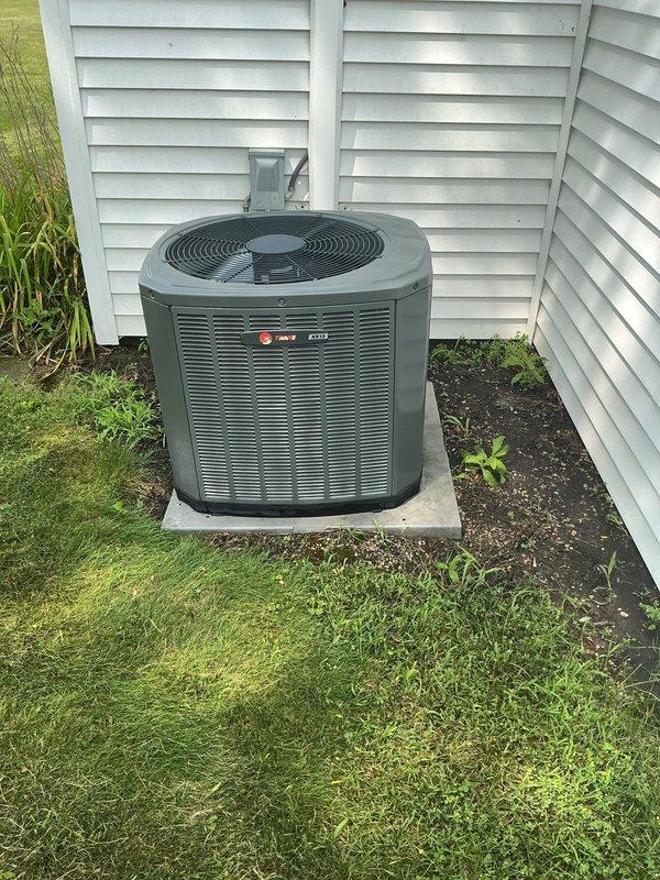Completed final air conditioning preventive maintenance on Trane cooling system. Inspected outdoor condensing unit positioned on concrete pad, verified proper operation of compressor and condenser fan, and confirmed adequate clearance from vegetation. Evaluated indoor Trane XC95 furnace with integrated cooling coil, checked refrigerant levels, tested electrical connections at disconnect, and replaced air filter. System operating within manufacturer specifications with maintenance agreement extended through February 2027.