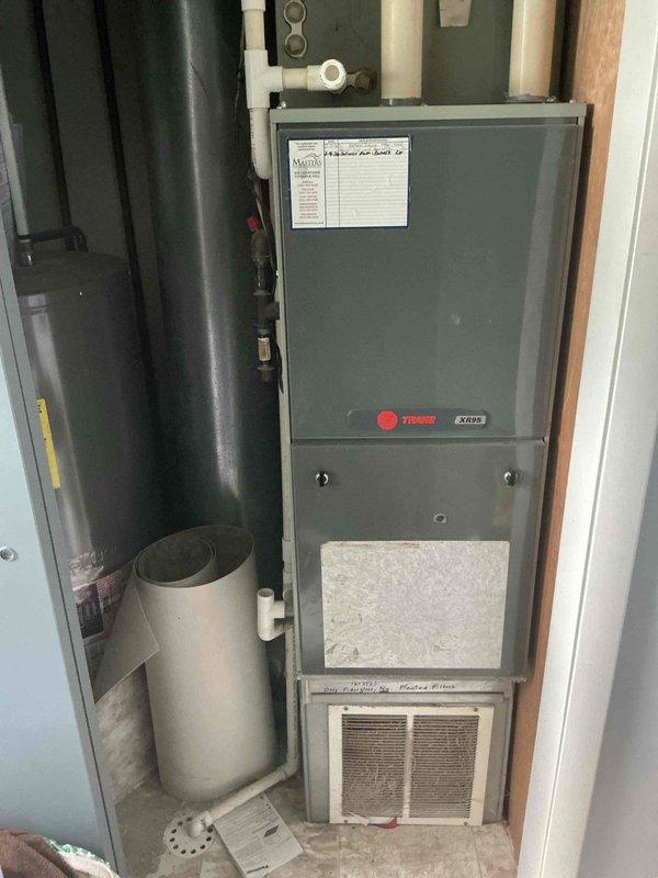 Completed final air conditioning preventive maintenance on Trane cooling system. Inspected outdoor condensing unit positioned on concrete pad, verified proper operation of compressor and condenser fan, and confirmed adequate clearance from vegetation. Evaluated indoor Trane XC95 furnace with integrated cooling coil, checked refrigerant levels, tested electrical connections at disconnect, and replaced air filter. System operating within manufacturer specifications with maintenance agreement extended through February 2027.