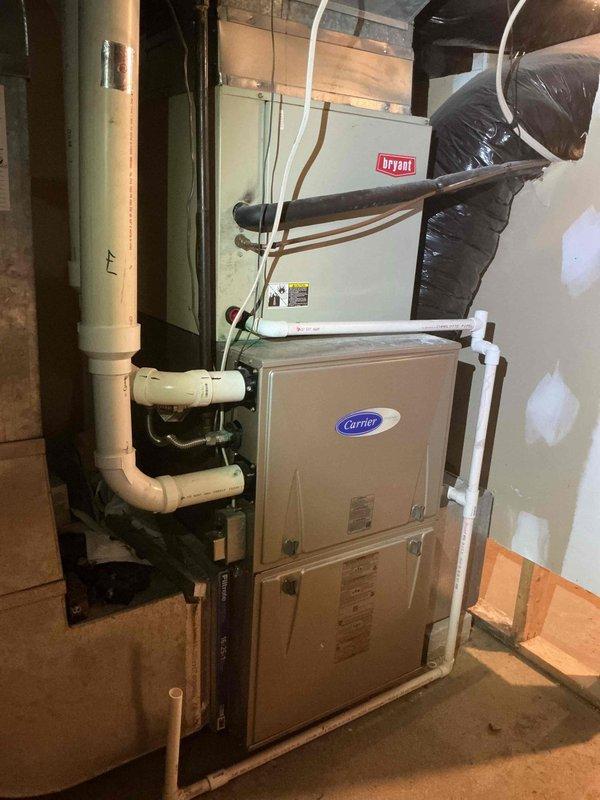 Completed first-part cooling preventive maintenance on residential HVAC system with dual-unit basement installation featuring Carrier air handler and Bryant equipment. Replaced heavily soiled 16x25x1 air filter showing significant dust and debris accumulation. Inspected system components, verified proper operation of cooling equipment, checked refrigerant lines and condensate drainage connections, and ensured all units were functioning correctly for the cooling season.