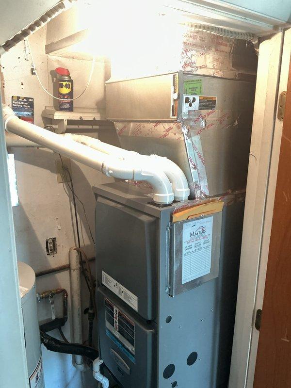Completed full HVAC system installation in residential utility closet with space constraints requiring coordination with plumbing work. Removed and recycled existing equipment, then installed new Carrier 26SPA630W003 Performance Series single-stage air conditioner and Carrier CVAVA3617XMA evaporator coil. Repositioned furnace lower in closet to achieve proper PVC condensate drain positioning per specifications. Reconnected existing supply and return ductwork to air handler. Flushed, pressure tested, and reconnected to existing refrigerant line set. Installed new electrical disconnect and whip for outdoor unit. Set outdoor condenser on new 2-inch PVC pad with pea gravel base for proper drainage and stability. Verified all connections, performed system startup, and confirmed proper operation of complete cooling system. Registered equipment warranty with manufacturer. Conducted system operation walkthrough explaining thermostat controls and maintenance requirements. Senior technician perf