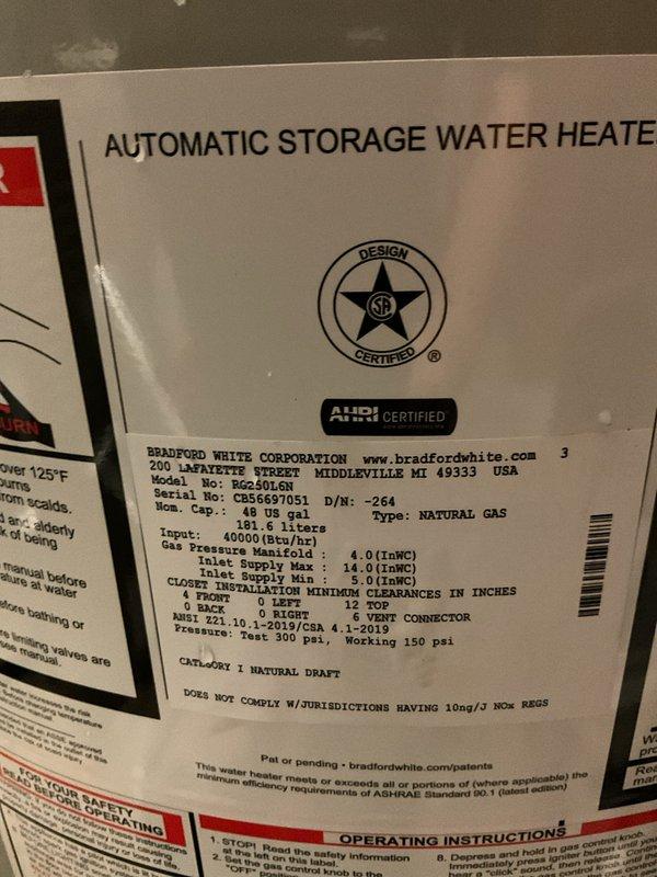 Responded to service call for leaking tanked gas water heater in basement utility area. Upon arrival, confirmed customer had shut off water supply to the unit to prevent further water damage. Performed thorough inspection of Bradford White 48-gallon natural gas water heater (Model CB56697051, 40,000 BTU input rating). Assessed unit condition, examined all plumbing connections, gas lines, and surrounding water treatment system. Documented existing installation configuration including red supply piping, ventilation ductwork, and adjacent blue water filtration tank. Photographed water heater specifications, manufacturer labels, and overall equipment setup for service records. Identified leak source and evaluated repair versus replacement options based on unit age and condition. Provided technical recommendations to homeowner for resolution of the leak issue.