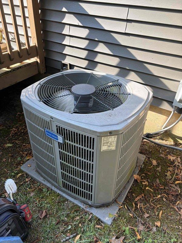 Completed first prepaid preventive maintenance visit on residential cooling system. Performed comprehensive inspection of outdoor condenser unit, including electrical connections at contactor assembly with multi-pole relay configuration. All wire terminations at brass screw terminals were verified secure, and contactor operation was tested under load. Cleaned condenser coil and fan assembly, removed debris and leaf accumulation from unit perimeter and base. System operating within normal parameters upon completion of maintenance procedures.