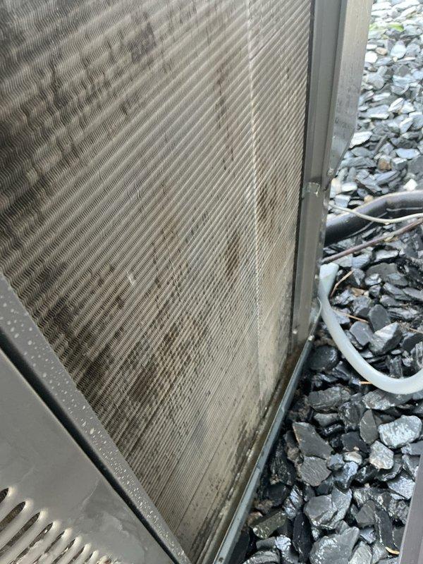 Performed comprehensive AC tune-up and cleaning on outdoor condensing unit. Upon arrival, found condenser coils heavily soiled with accumulated dirt, dust, and environmental debris significantly restricting airflow through heat exchanger fins. Thoroughly cleaned condenser coils to restore proper heat transfer efficiency and system performance. Completed full system inspection and operational checkout to ensure unit functioning within manufacturer specifications.