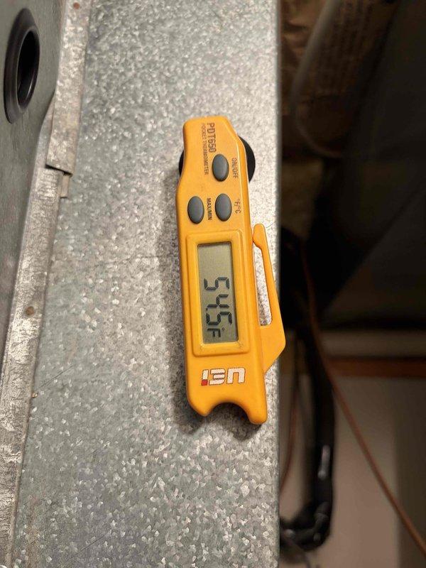 Completed first annual air conditioning maintenance visit on residential cooling system. Performed comprehensive inspection of outdoor condenser unit, verified proper operation of compressor and fan motor, checked refrigerant levels and system temperatures with digital thermometer recording 55.5°F at evaporator coil, inspected electrical connections and disconnect box, and confirmed unit is operating within manufacturer specifications. System is in good working condition with maintenance contract valid through December 2026.