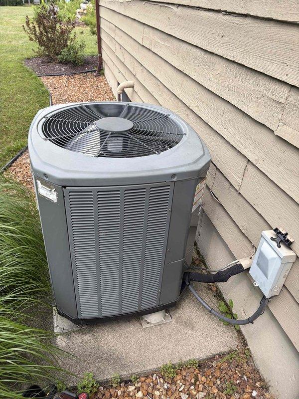 Completed first annual air conditioning maintenance visit on residential cooling system. Performed comprehensive inspection of outdoor condenser unit, verified proper operation of compressor and fan motor, checked refrigerant levels and system temperatures with digital thermometer recording 55.5°F at evaporator coil, inspected electrical connections and disconnect box, and confirmed unit is operating within manufacturer specifications. System is in good working condition with maintenance contract valid through December 2026.