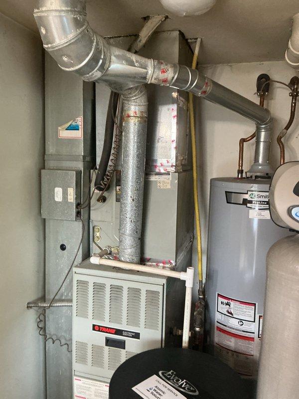 Completed HVAC estimate for equipment replacement in residential mechanical room. Assessed existing Trane furnace, A.O. Smith water heater, ductwork configuration, electrical connections, and gas line routing. Documented current system layout including ventilation components, expansion tank, and utility connections. Photographed equipment conditions, clearances, and existing infrastructure to provide comprehensive replacement recommendations and specifications.