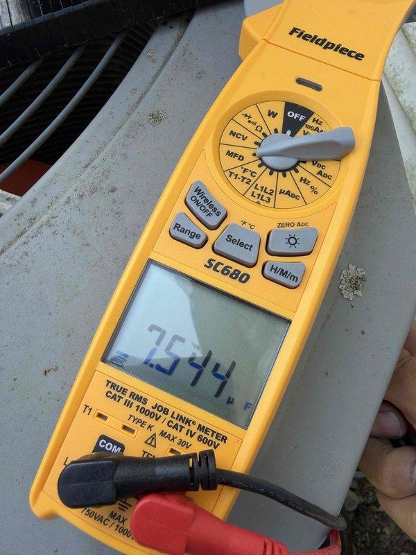 Completed final prepaid cooling maintenance visit on outdoor heat pump unit. Performed standard system inspection with unit access for internal component evaluation, observed compressor and refrigerant lines in operational condition with normal moisture present. Documented system readings using clamp meter showing 757.4 measurement value, verified electrical connections and mechanical components functioning within normal parameters.