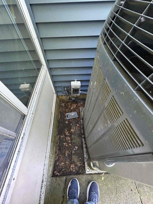Responded to service call for non-functional outdoor HVAC unit with failed compressor. Conducted thorough assessment of existing system located in confined exterior space between building wall and window, noting significant age-related deterioration, weathering, and debris accumulation around unit. Evaluated indoor furnace component housed in utility closet to determine compatibility requirements for replacement system. Documented current equipment condition through photographs and prepared comprehensive estimate for complete system replacement due to compressor failure rendering existing unit beyond economical repair.