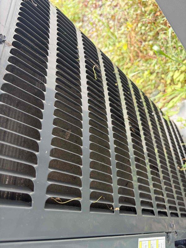Responded to no cooling complaint on Goodman air conditioning unit of unknown age. Upon arrival, confirmed unit was running but providing insufficient cooling capacity. Performed comprehensive system diagnostics including refrigerant pressure testing, electrical component verification, and airflow assessment. Inspected outdoor condenser unit which showed signs of restricted airflow due to debris accumulation and vegetation growth around base. Cleaned condenser coils and cleared obstructions from unit perimeter to restore proper air circulation. Verified fan motor operation and checked capacitor readings within normal parameters. System tested successfully after service with proper temperature differential achieved across evaporator coil and adequate cooling restored to occupied space.