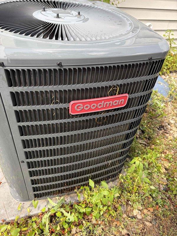 Responded to no cooling complaint on Goodman air conditioning unit of unknown age. Upon arrival, confirmed unit was running but providing insufficient cooling capacity. Performed comprehensive system diagnostics including refrigerant pressure testing, electrical component verification, and airflow assessment. Inspected outdoor condenser unit which showed signs of restricted airflow due to debris accumulation and vegetation growth around base. Cleaned condenser coils and cleared obstructions from unit perimeter to restore proper air circulation. Verified fan motor operation and checked capacitor readings within normal parameters. System tested successfully after service with proper temperature differential achieved across evaporator coil and adequate cooling restored to occupied space.
