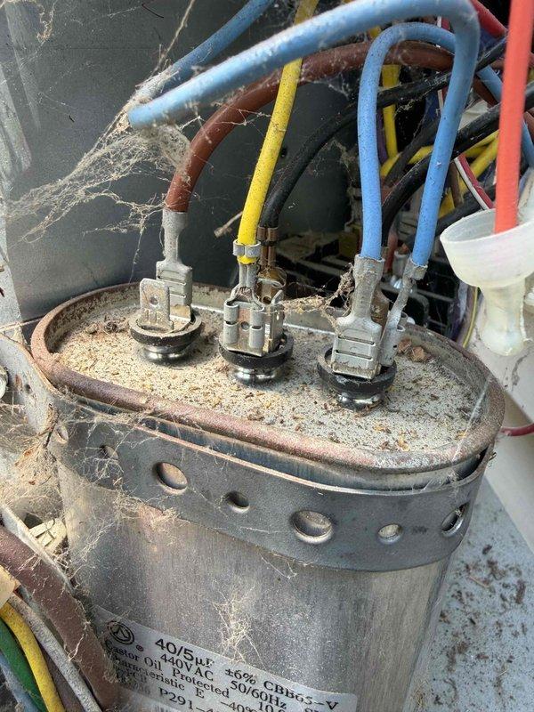 Completed comprehensive cooling tune-up on AC unit, including inspection of all electrical components and connections. Identified heavily corroded capacitor with significant rust, deterioration, and debris accumulation; replaced capacitor with new unit to restore proper system operation and prevent potential failure.