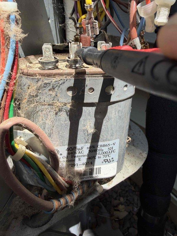 Completed comprehensive cooling tune-up on AC unit, including inspection of all electrical components and connections. Identified heavily corroded capacitor with significant rust, deterioration, and debris accumulation; replaced capacitor with new unit to restore proper system operation and prevent potential failure.
