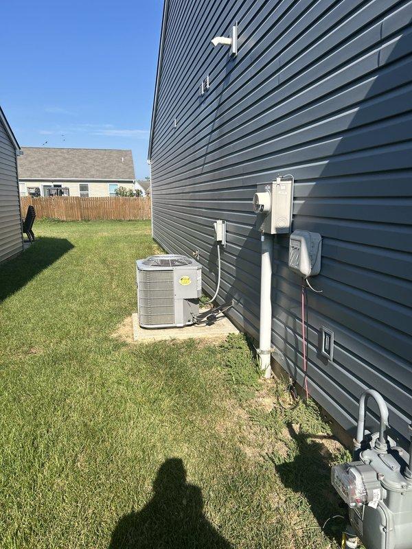 Conducted comprehensive assessment of existing HVAC system following previous inspection indicating failed evaporator coil. Evaluated outdoor condensing unit positioned on concrete pad with electrical disconnect and utility connections. Provided detailed replacement estimate for air conditioning system with optional furnace replacement based on equipment compatibility and system efficiency requirements. Documented current equipment configuration including condenser unit, electrical service connections, and gas utility infrastructure to determine optimal replacement specifications.