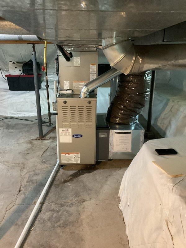 Completed full HVAC system replacement including installation of Carrier 58SB0A070E17-12 single-stage gas furnace (80% AFUE), Carrier CVAVA3017XMA evaporator coil, and Carrier 26SCA424N003 single-stage air conditioner with Honeywell S200 FocusPRO thermostat. Removed and recycled existing equipment, reconnected to existing supply and return ductwork, flushed and pressure tested existing line set, installed new electrical disconnect and whip, and installed new 2" condensate drain line. Performed system startup, verified proper refrigerant charge and temperatures using digital manifold gauges, completed operational testing of heating and cooling modes, and conducted post-installation quality assurance walkthrough with system operation explanation.