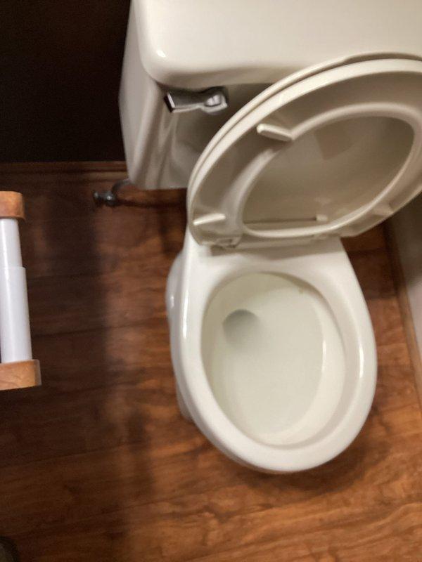 Responded to after-hours service call for unstable toilet in guest bathroom. Upon inspection, confirmed toilet was wobbling at base, indicating failed wax ring seal. Removed toilet from floor flange, scraped old wax ring and debris from both flange and toilet base, inspected flange for damage, installed new wax ring, reset toilet to proper position, secured with new closet bolts, and tested for stability and proper seal.