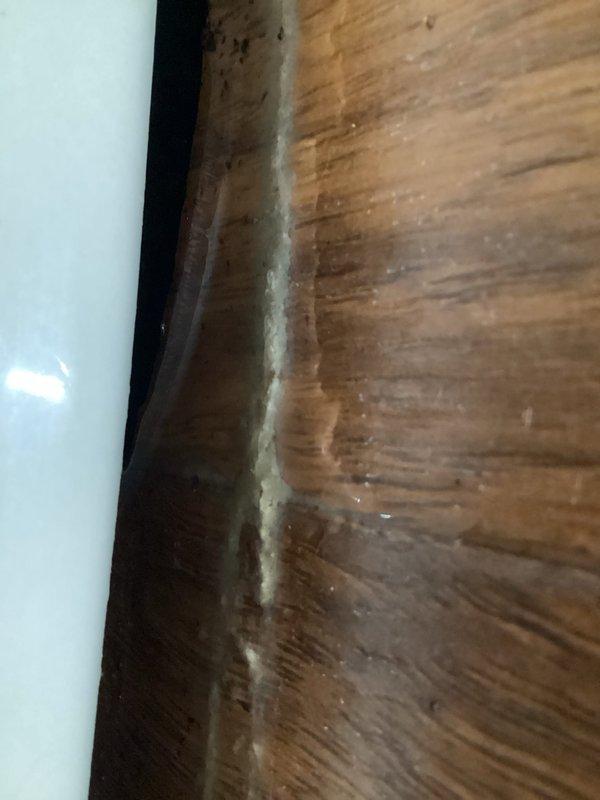 Responded to after-hours service call for unstable toilet in guest bathroom. Upon inspection, confirmed toilet was wobbling at base, indicating failed wax ring seal. Removed toilet from floor flange, scraped old wax ring and debris from both flange and toilet base, inspected flange for damage, installed new wax ring, reset toilet to proper position, secured with new closet bolts, and tested for stability and proper seal.