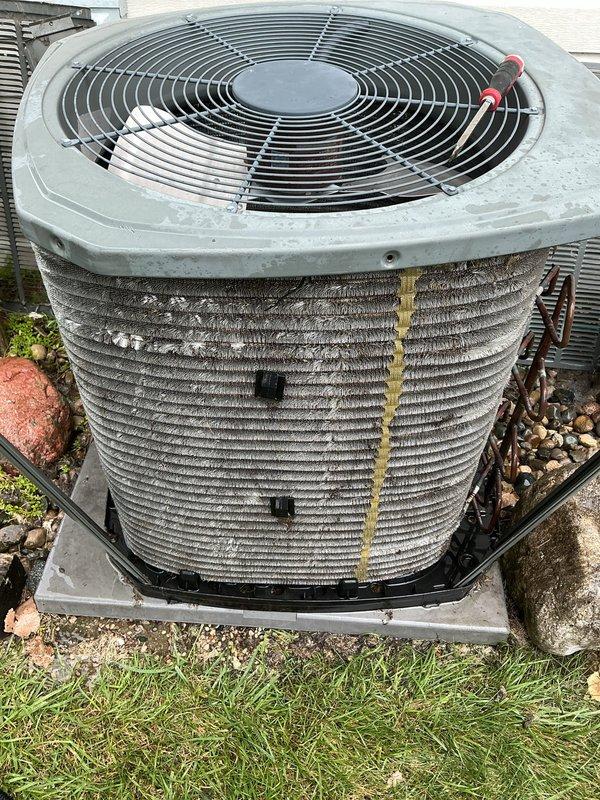 Completed first annual air conditioning maintenance visit on residential cooling system. Performed comprehensive inspection of outdoor condenser unit, including visual examination of condenser coils which showed moderate dirt and debris accumulation between aluminum fins. Assessed refrigerant lines, electrical connections, and fan assembly operation. Unit was found operational with normal wear consistent with outdoor exposure. Documented equipment condition through photographic records showing condenser coils, fan guard assembly, and overall unit placement on concrete pad with proper drainage pan installed.