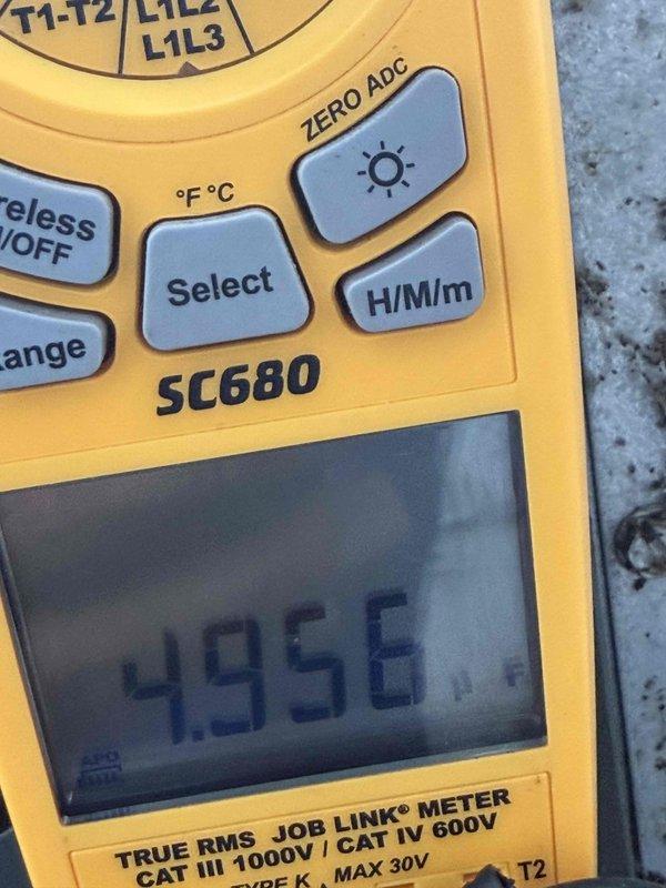Completed first prepaid cooling system maintenance visit. Performed comprehensive system inspection and diagnostic testing using digital multimeter, recording temperature readings of 495°F at critical measurement points. Inspected dual-rated capacitor (45/5 MFD, 440V AC) with all four terminal connections intact and functioning properly, confirmed proper wire connections on compressor, fan, and common terminals.