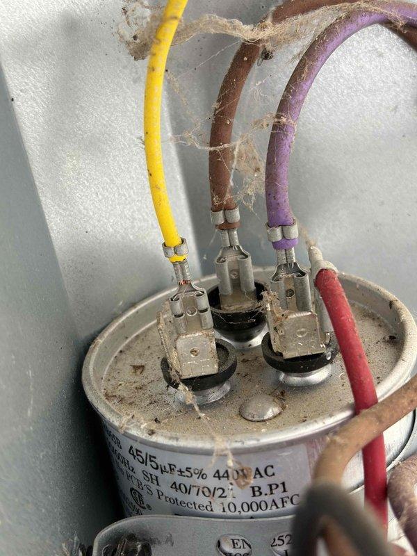 Completed first prepaid cooling system maintenance visit. Performed comprehensive system inspection and diagnostic testing using digital multimeter, recording temperature readings of 495°F at critical measurement points. Inspected dual-rated capacitor (45/5 MFD, 440V AC) with all four terminal connections intact and functioning properly, confirmed proper wire connections on compressor, fan, and common terminals.