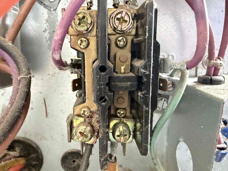 Completed prepaid cooling maintenance visit on residential HVAC system. Upon inspection, discovered severely rusted capacitor with deteriorated wiring connections and corroded electrical terminal block with multiple discolored brass screws showing signs of age and oxidation. Documented equipment condition with photographs for maintenance records. System components exhibited extensive environmental exposure and corrosion requiring attention for continued safe operation.