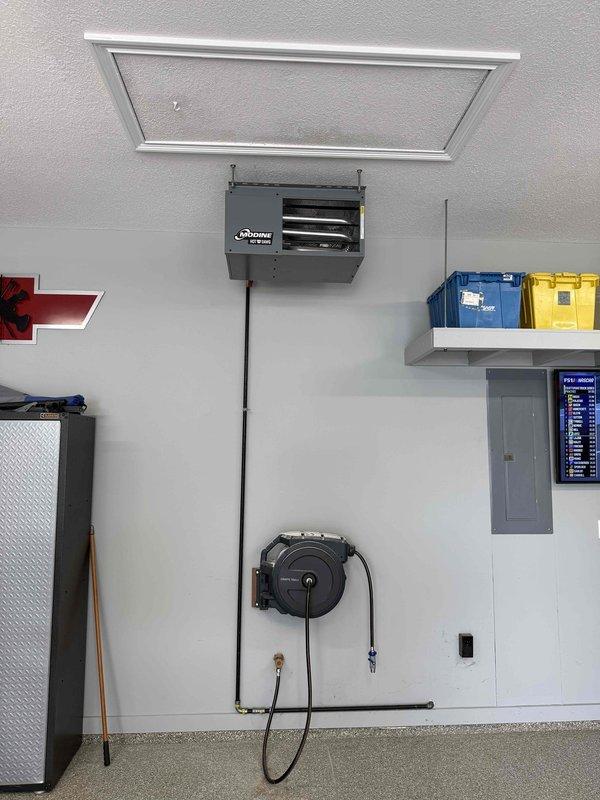 Successfully installed one Modine Hot Dawg unit heater (Model MDHD30AS0111, 30,000 BTU) in garage workspace, mounted near ceiling with proper ductwork connections. Converted unit to LP operation by installing and configuring LP conversion kit. Completed all manufacturer-specified startup procedures, verified proper operation, ignition sequence, and heat output to ensure system functionality and safety compliance.