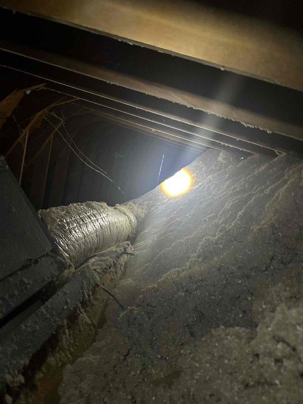Conducted comprehensive HVAC system assessment in attic space to provide replacement estimate. Inspected existing ductwork configuration, including flexible metallic ducts and return air plenum connections. Evaluated current system accessibility, structural clearances, and electrical infrastructure to determine optimal replacement equipment specifications and installation requirements. Documented existing conditions through detailed photography of duct runs, plenum assembly, and attic workspace constraints for accurate proposal development.