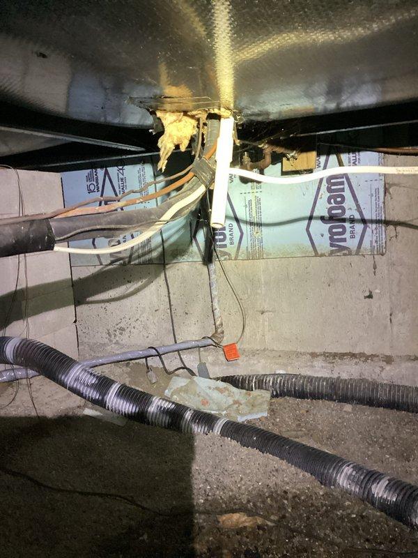 Responded to elevated water consumption complaint and conducted crawl space inspection beneath kitchen area. Located moisture accumulation on concrete floor in crawl space, consistent with reported water bill increase. Inspected exposed plumbing lines, floor joists, and foundation for active leaks or signs of water intrusion. Documented crawl space conditions including exposed ductwork, insulation, and plumbing infrastructure. Advised shutting off water supply to toilet exhibiting intermittent running to isolate potential contributing source of water waste. Noted secondary drainage concerns related to kitchen garbage disposal requiring plunging for proper function, which may indicate partial line obstruction. Photographed affected crawl space area showing moisture staining on concrete surfaces and overall utility space conditions for diagnostic reference.
