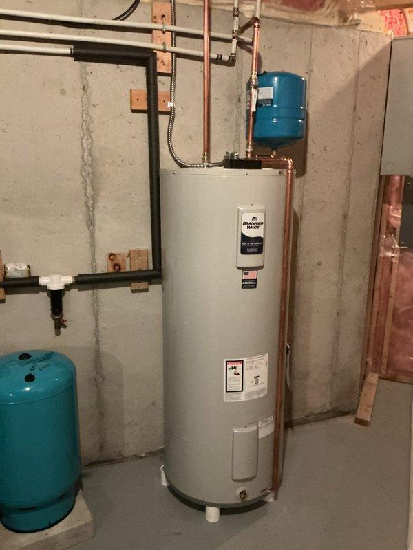 Installed one 80-gallon Bradford White electric water heater (model BSLE280T6-1) in basement location. Mounted 2.5-gallon expansion tank on cold water inlet line per code requirements. Rerouted cold water supply piping to new heater and reconnected hot water distribution to existing plumbing system. Installed dedicated 30-amp electrical circuit from main breaker panel to water heater using appropriate gauge wiring and flexible metal conduit. All copper pipe connections soldered and tested for leaks. Unit energized and tested for proper operation. System includes 6-year tank and parts warranty with 1-year labor coverage.