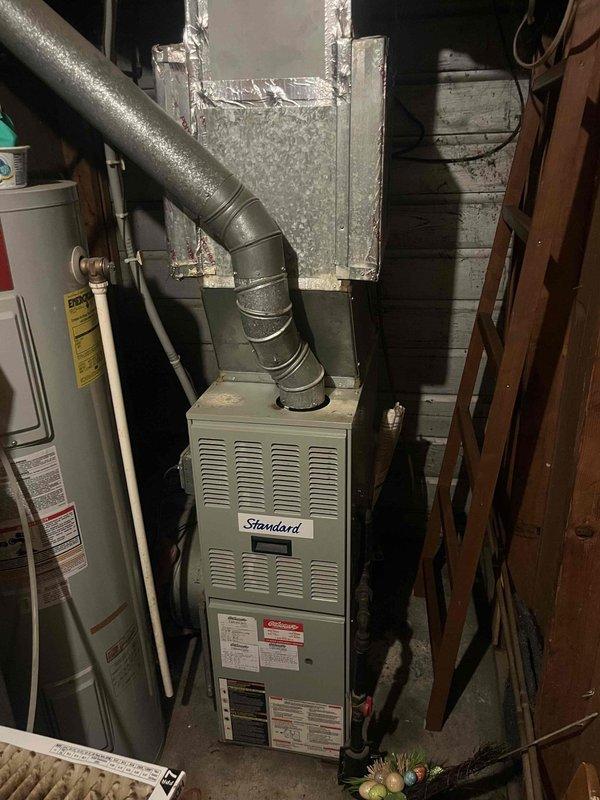 Responded to no cooling complaint on residential split system with American Standard Allegiance 12 outdoor unit (Model 7A2030A100A2, manufactured 02/2001, 23+ years old). Upon arrival, customer reported unit running but not providing cooling to home. Performed diagnostic evaluation of outdoor condensing unit and indoor air handler system. Documented equipment condition with photos showing significant age-related wear, outdoor environmental exposure, dirt accumulation on condenser housing, and overall degradation consistent with unit exceeding expected service life. System assessment revealed equipment operating beyond manufacturer's typical 15-20 year lifespan, indicating high probability of component failure or refrigerant system issues. Given the age and condition of the unit, discussed replacement options with customer as most cost-effective long-term solution versus investing in repairs on equipment that has exceeded its useful service life.
