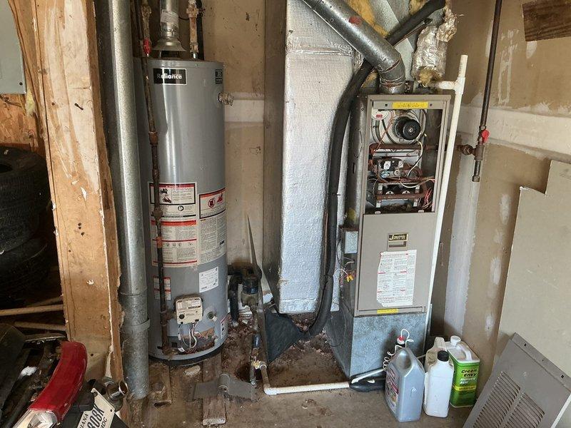 Conducted on-site assessment for gas furnace replacement in residential property. Evaluated existing HVAC system consisting of aging furnace unit with beige cabinet and adjacent water heater in basement mechanical room. Documented current equipment specifications, venting configuration with flexible ductwork, and existing Braeburn thermostat. Provided comprehensive replacement estimate for new gas furnace installation to address customer's heating system upgrade needs.