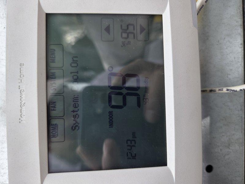 Responded to service call for mini split system experiencing severe water leakage from indoor unit in men's bathroom and outdoor condenser unit. Upon arrival, observed excessive dripping from both components indicating potential condensate drain blockage. Documented system conditions including thermostat reading of 98°F and ground-mounted outdoor unit location. Initial assessment revealed unit requires thorough cleaning due to heavily soiled condition. Additional concerns noted with ground-level RTU showing signs of refrigerant leakage requiring further diagnostic evaluation by specialized technician due to system complexity.