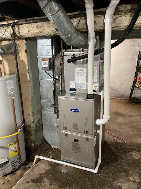 Completed full HVAC system replacement in basement mechanical room, installing Carrier Comfort Series single-stage air conditioner model 26SCA430N003, Carrier evaporator coil model CVAVA3617XMA, and Carrier Comfort Series single-stage gas furnace model 59SC6A080M17--16 with Honeywell S200 FocusPro thermostat. Removed and recycled existing equipment, reconnected to existing supply and return ductwork and line set, installed new disconnect and whip, and completed furnace changeout using #2 installation kit. Verified system operation with refrigerant pressure readings of 395 psig on high side with 96°F subcooling and 844°F saturated temperature, performed post-installation quality assurance inspection, explained system operation to homeowner, registered equipment warranties, and obtained necessary permits.