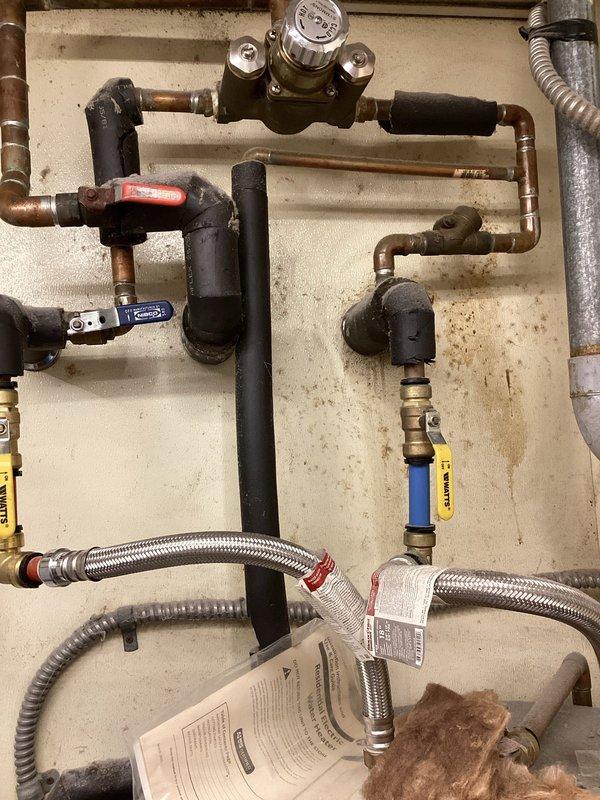 Responded to emergency service call for no hot water at kitchen sink in baby care area. Upon arrival, inspected water heater system and associated plumbing connections. Examined gas supply lines, shut-off valves, pressure regulator, and flexible supply lines connected to tanked water heater unit. Verified proper operation of gas control valves including red-handled and blue-handled shut-offs. Inspected electrical connections and wiring terminals at junction box. Tested hot water distribution system and confirmed restoration of hot water flow to kitchen sink fixture. All safety checks completed and system returned to normal operation.