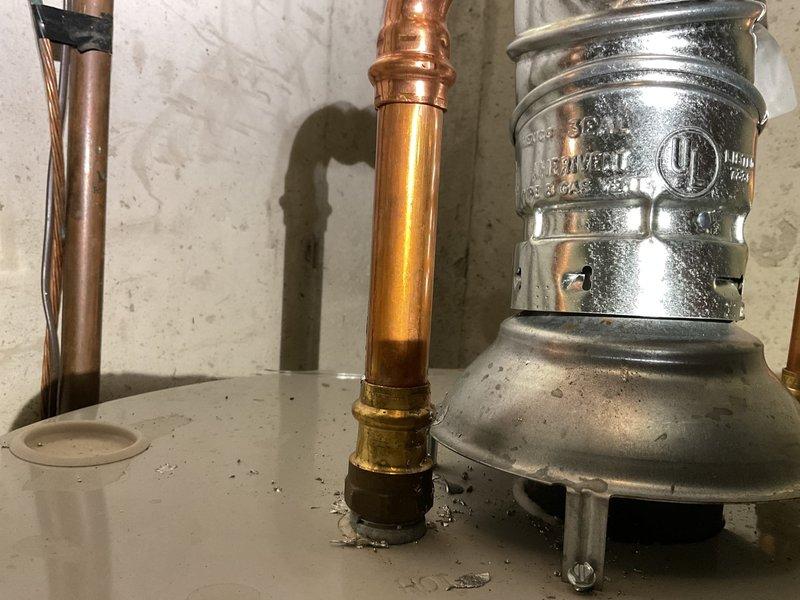 Responded to inspection report callback for plumbing installation review. Upon arrival, inspected water heater connections and associated piping system in basement utility area. Verified proper installation of mixed copper and PVC piping configuration, including galvanized vertical supply lines with appropriate condensation management. Examined all pipe joints, elbows, and fittings for proper connection integrity. Confirmed UL-listed coupling components were correctly installed per manufacturer specifications. Checked mounting brackets securing horizontal PVC runs to ensure adequate support. Inspected copper pipe connections to water heater with brass fittings, verifying proper solder joints and no signs of leakage. Documented all plumbing connections, pipe materials, and installation methods with photographs for inspection compliance records. All components found to be properly installed with correct materials and meeting current plumbing code requirements.