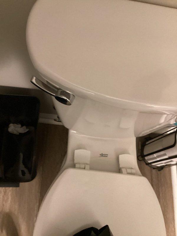 Responded to report of toilet leaking from the base during flushing. Upon arrival, removed toilet to inspect the flange and wax ring seal. Found the toilet flange severely corroded and deteriorated with significant rust damage, which compromised the seal integrity and caused water to leak from beneath the fixture. Replaced the corroded flange assembly and installed new wax ring to create proper watertight seal between toilet and drain pipe. Reinstalled toilet, secured mounting bolts, reconnected water supply, and tested flush cycles to confirm leak was eliminated and proper operation restored.
