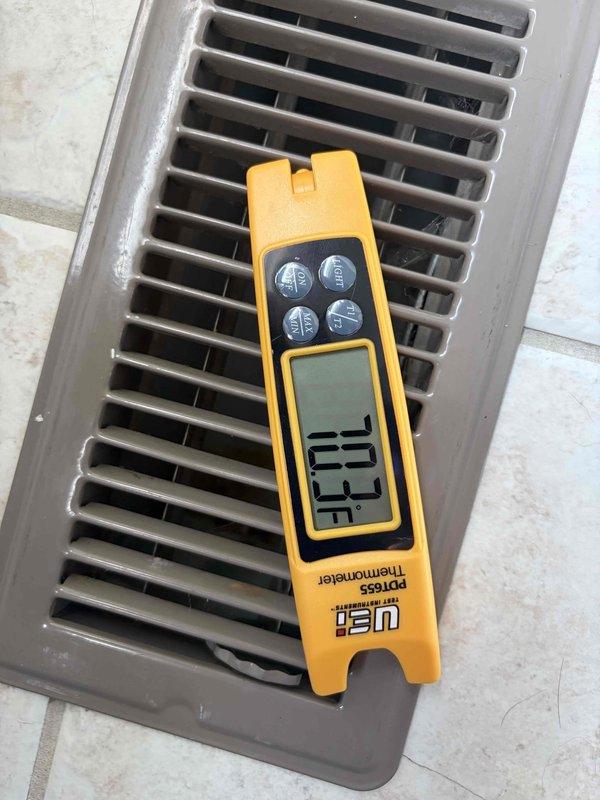 Performed comprehensive gas furnace tune-up in garage. Conducted combustion analysis using digital gas analyzer, measuring oxygen levels, carbon monoxide (10.89%), carbon dioxide (20 ppm), and combustion efficiency (97.9%). Verified proper temperature output at floor register using digital thermometer to ensure adequate heat distribution throughout the system.