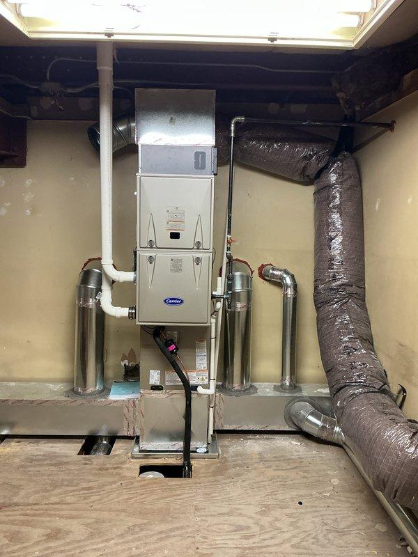 Completed full HVAC system installation including a Carrier 59TP7A060V17 60,000 BTU two-stage 96% efficiency natural gas furnace, Carrier 2.5 ton cased coil, and Carrier 26SCA430N003 2.5 ton 14 SEER single-stage air conditioner with R-454B refrigerant. Installed Honeywell T6 thermostat, refrigerant line set, 4-inch media filter cabinet with filter, PVC flue venting, and exterior condenser pad. Ran main trunk line and insulated flex ductwork throughout, installed return ductwork in walls, and placed all registers and grilles. Connected condensation drain line and extended gas line from existing supply to new furnace location. Completed system startup, tested all functions including two-stage heating operation and single-stage cooling, verified proper airflow and temperature differentials across all zones, and confirmed thermostat programming and control sequences operating correctly.