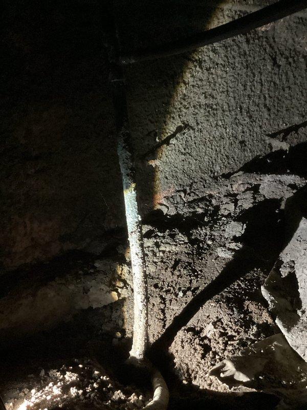 Responded to service call for leaking outdoor spigot and suspected pipe leak in crawl space. Accessed crawl space through 2'x2' closet opening to inspect plumbing infrastructure with approximately 3 feet of clearance. Documented corroded outdoor spigot fixture showing significant oxidation and mineral deposits, as well as pipe condition in crawl space area with exposed insulation. Advised customer that repair of outdoor spigot and associated piping may require coordination with city water department for main shutoff due to absence of property shutoff valve.