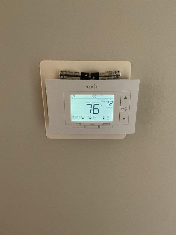 Performed comprehensive AC tune-up on residential cooling system per routine maintenance request. Inspected air handler unit, verified thermostat operation and calibration on Sensi WiFi-enabled model, confirmed cooling setpoint functionality at 72°F with system responding appropriately. Replaced thermostat batteries as preventative maintenance, checked all electrical connections, and documented equipment condition with no issues found during inspection.