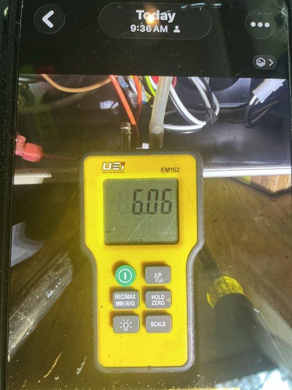 Installed 4" B-vent from furnace through roof to provide proper venting for combustion gases. Coordinated with roofing contractor on-site who supplied and installed flashing for metal roof penetration. Verified draft pressure readings using digital manometer, confirming proper system operation with readings of 6.05 and 11.22 recorded during testing and diagnostics.