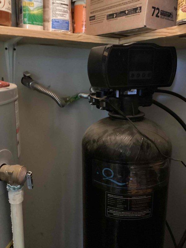 Conducted complimentary in-home consultation for whole house water treatment system installation. Assessed existing plumbing infrastructure including AO Smith water heater installed in 2016 located in utility area beneath sink cabinet. Evaluated customer preference for saltless water conditioning system and discussed available options. Documented current setup including water heater connections, flexible supply lines, PVC drainage system, and available installation space in utility closet area. Photographed existing equipment configuration and plumbing layout to facilitate accurate system design and quote preparation. Confirmed installation timeframe preference and provided technical recommendations for whole house water treatment solution compatible with current residential plumbing system.