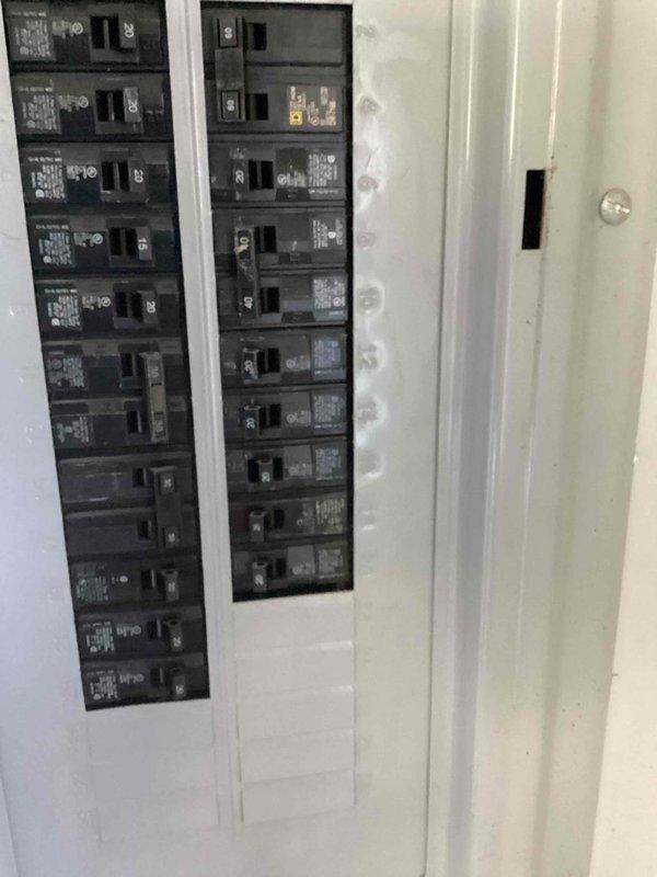 Provided estimate for replacing existing electric tank-style water heater with electric tankless unit in basement location. Evaluated electrical panel capacity, confirming 200-amp main service with available breaker positions to accommodate tankless water heater electrical requirements.