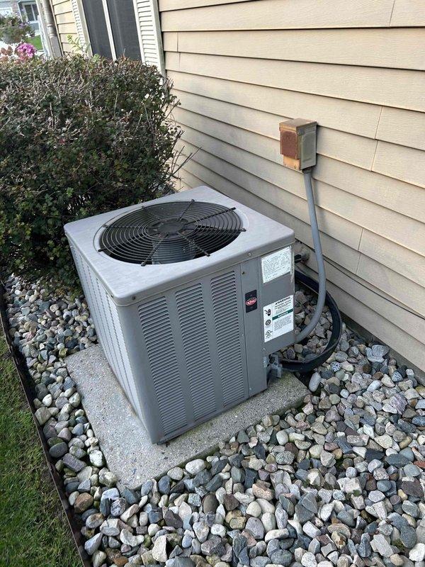 Performed an on-site furnace replacement estimate for an approximately 41-year-old original furnace located in a closet utility/laundry room, with no operational issues or symptoms reported. Documented the existing equipment, including the outdoor condenser unit (clear of frost, rust, or visible damage, with electrical disconnect and line set intact) and the wall-mounted digital thermostat, to determine system compatibility and replacement scope.