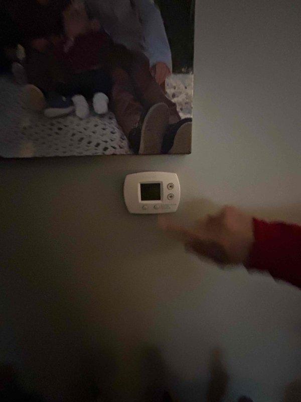 Performed an on-site furnace replacement estimate for an approximately 41-year-old original furnace located in a closet utility/laundry room, with no operational issues or symptoms reported. Documented the existing equipment, including the outdoor condenser unit (clear of frost, rust, or visible damage, with electrical disconnect and line set intact) and the wall-mounted digital thermostat, to determine system compatibility and replacement scope.