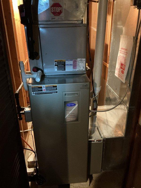 Performed a heating tune-up on a Carrier Infinity gas furnace with a stacked coil cabinet, inspecting the unit, condensate drain, venting, and ductwork connections with no visible rust, frost, or damage noted. Conducted a combustion analysis on natural gas, recording O2 at 8.83%, CO at 8 ppm, CO2 at 6.78%, flue temperature of 88.6°F, and combustion efficiency of 89.5%, confirming the furnace is operating safely and within normal parameters.